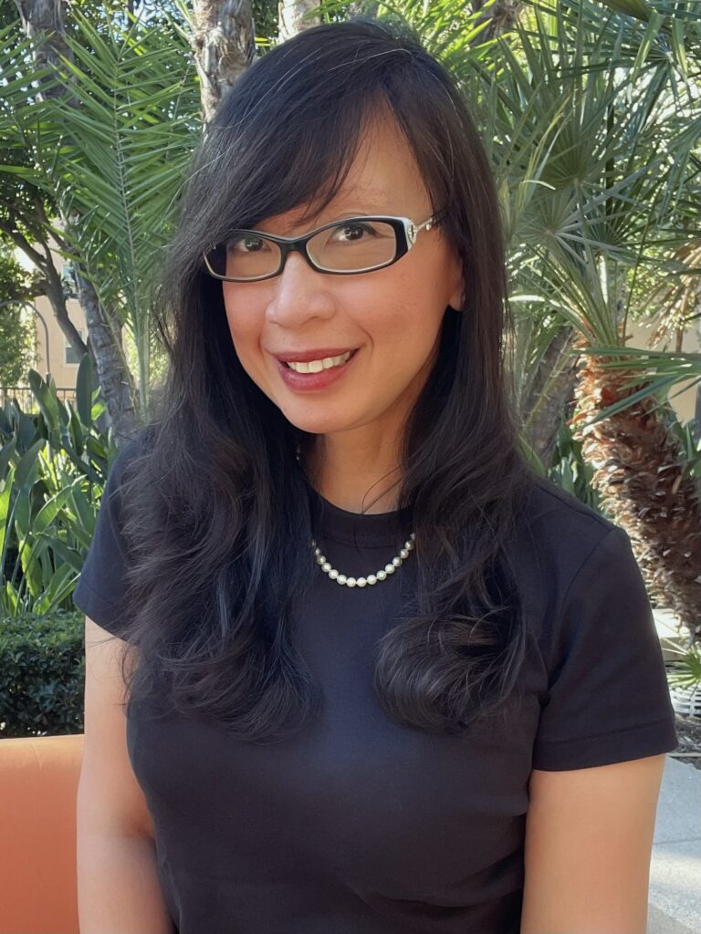 Ericka Lozada, fractional Chief of Staff at EL Business Operations and Development, smiling outdoors.